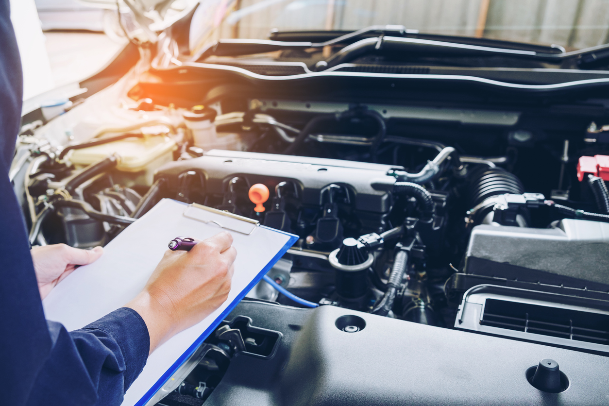 French Car Centre - Mechanic Holding Clipboard Car Service